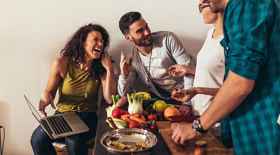 friends laughing cooking food