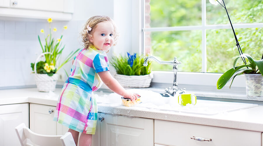 Littler girl cleaning kitchen