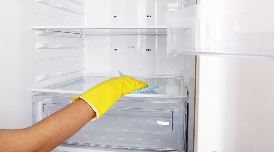 Wiping down fridge